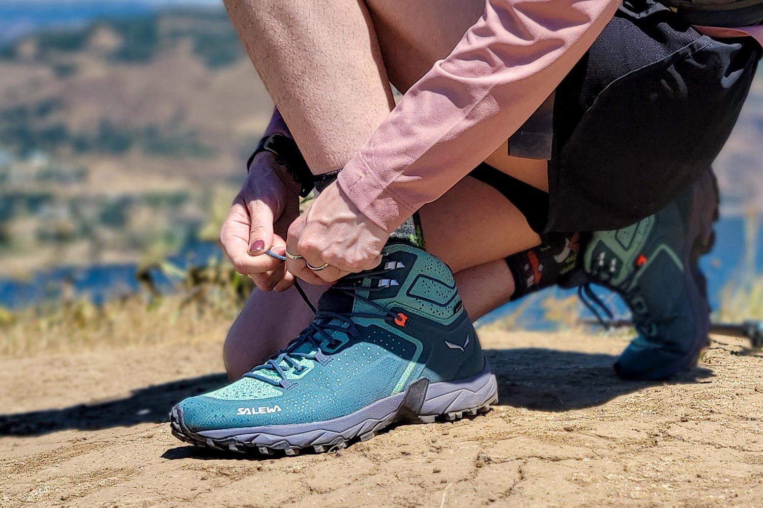 A hiker tying the laces on the Salewa Alpenrose Ultra Boots
