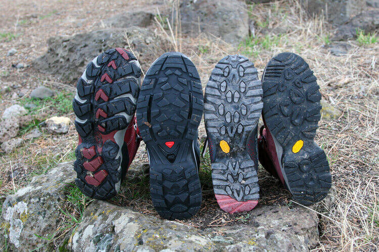 Comparing tread patterns on the Oboz Bridger Mid BDry, Salomon Quest 4D 3 GTX, La Sportiva Nucleo High GTX, and Vasque Breeze III Mid GTX.